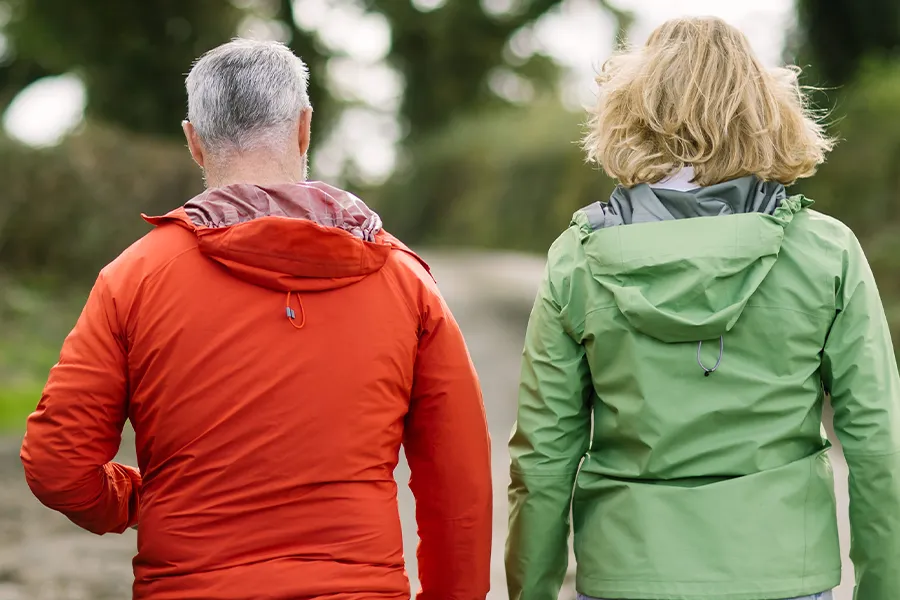 Speech, language and communication therapist Rowan Ranner walking with client along country lane